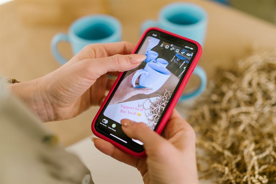 Hands scrolling a social media story on a phone